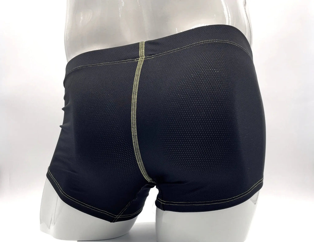 Black mesh boxer briefs on a mannequin, featuring prominent yellow contrast stitching along the seams.