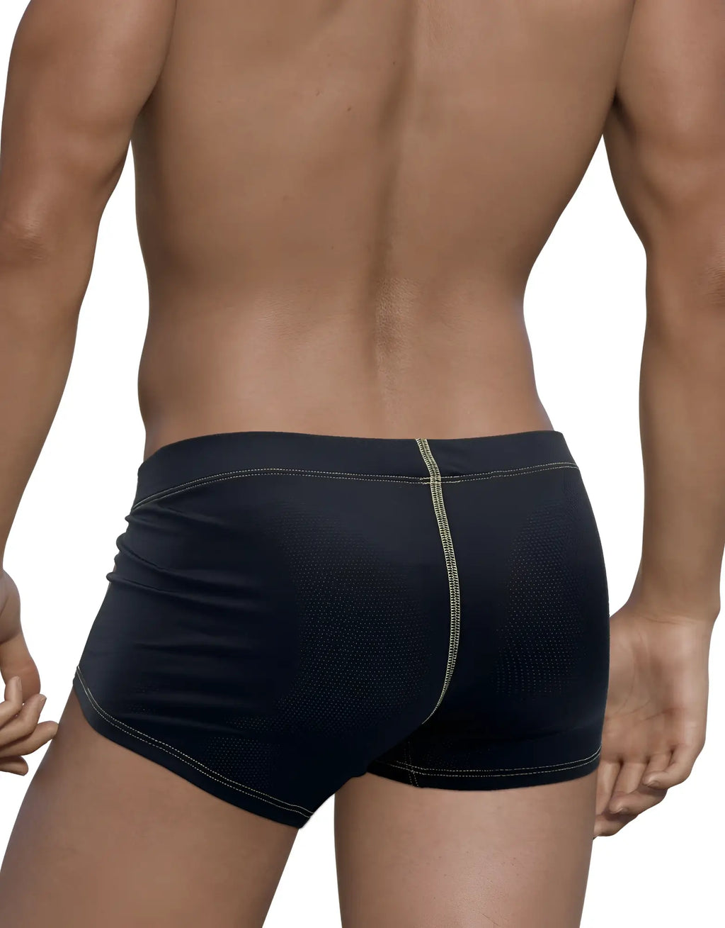 Back view of black perforated boxer briefs with yellow contrast stitching on a muscular man.