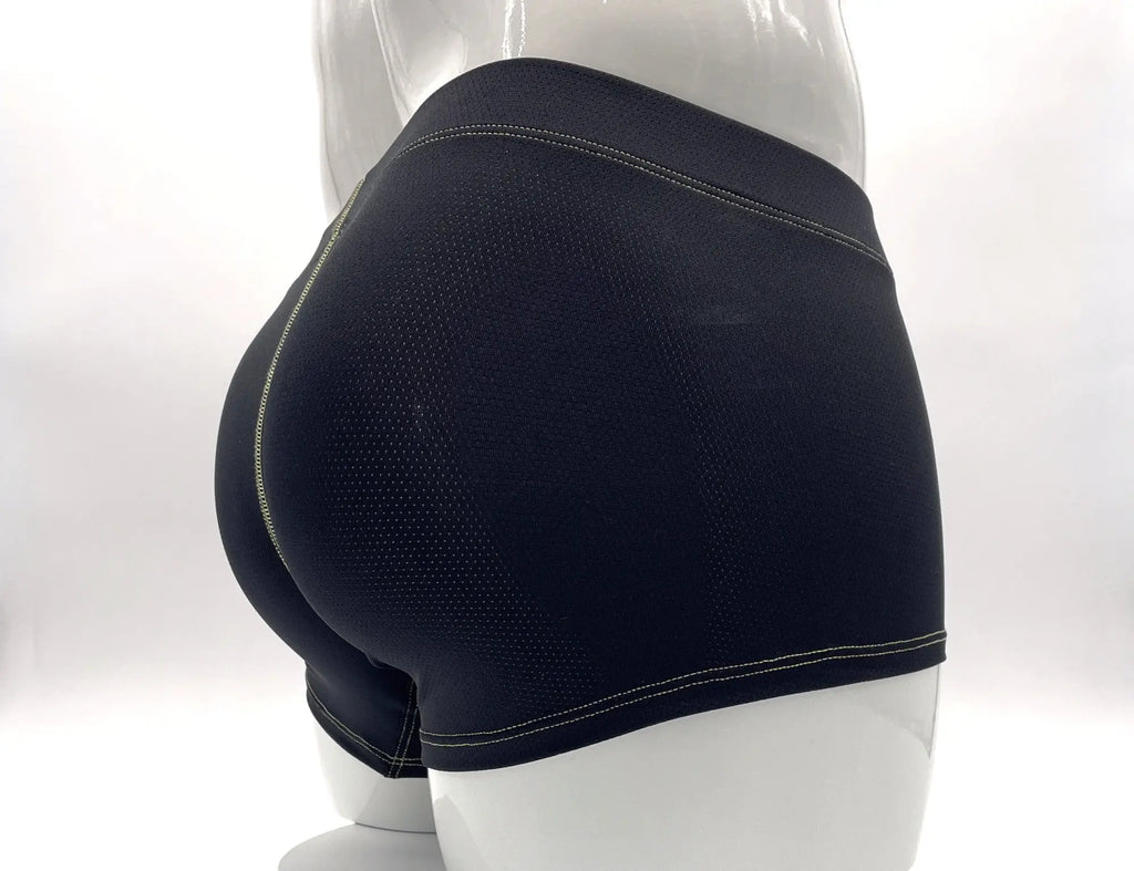 Black perforated boxer briefs featuring contrasting yellow stitching on a white mannequin.