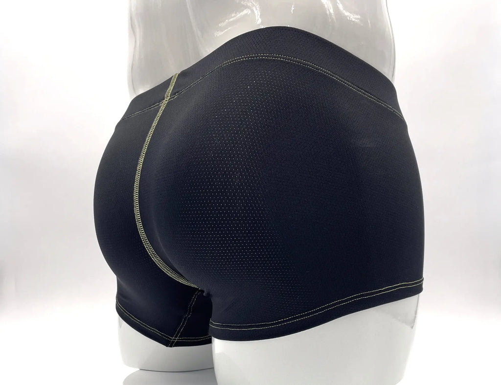 Back view of black mesh boxer briefs on a mannequin, featuring prominent yellow contrast stitching.