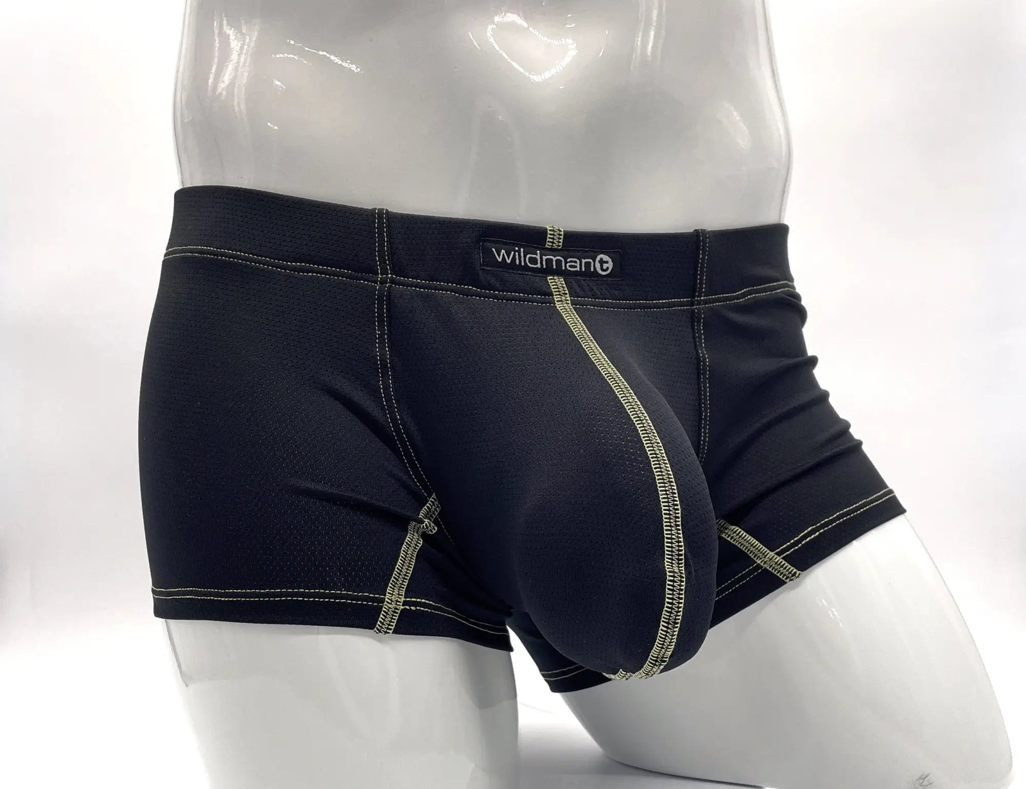 Black pouch boxer briefs with yellow stitching, worn by a mannequin. Features a prominent front pouch and logo tab.