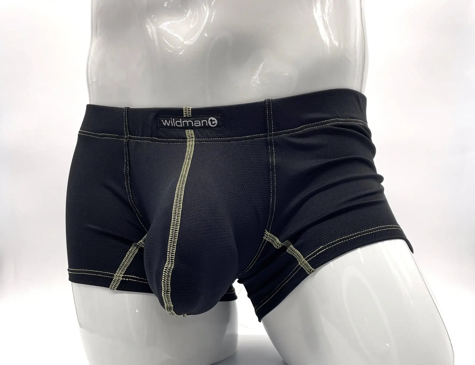 Black boxer briefs with a large front pouch and contrasting yellow stitching, shown on a white mannequin.