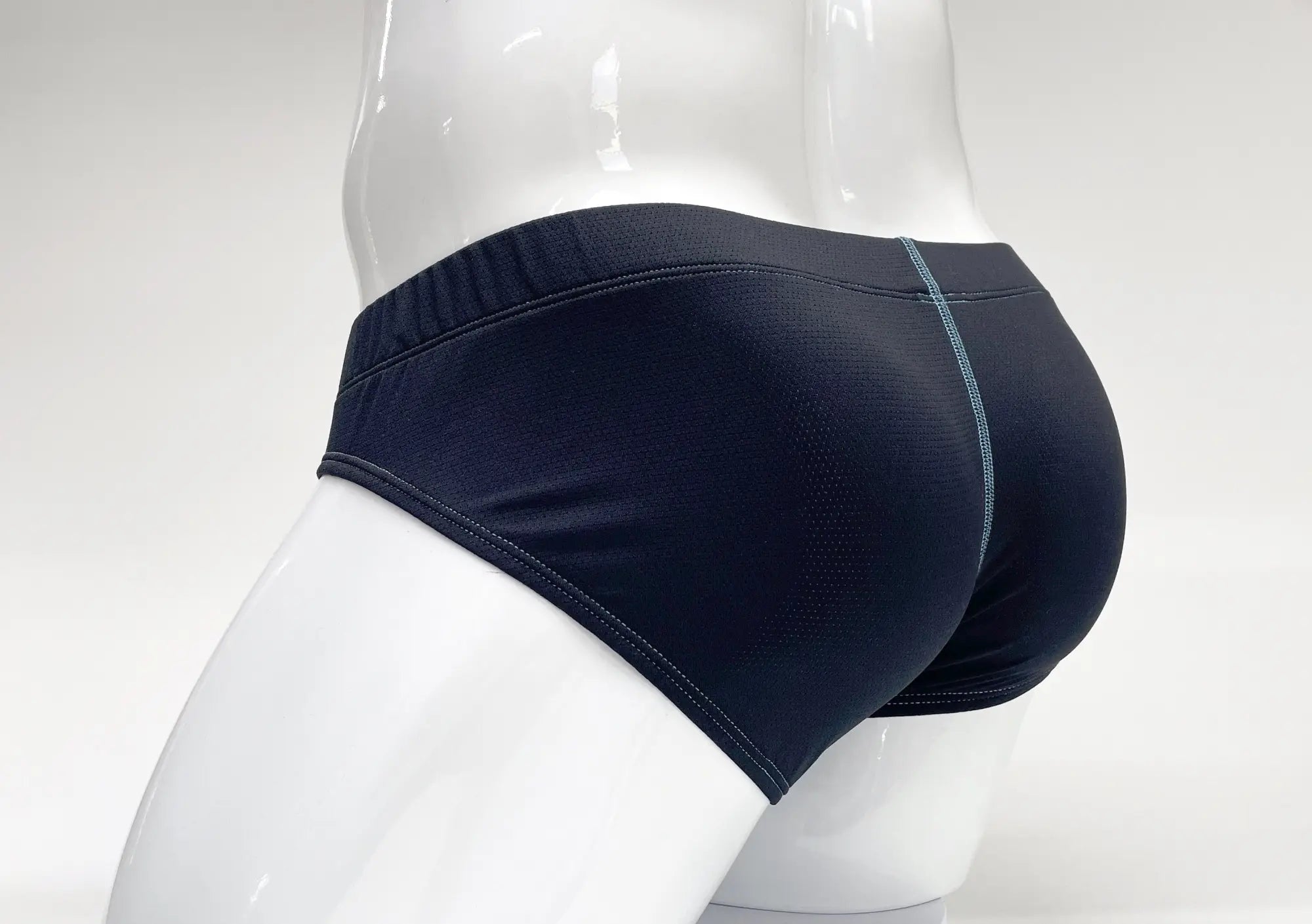 Stitch Big Boy pouch briefs in navy blue textured fabric with contrasting teal stitching on a white mannequin.
