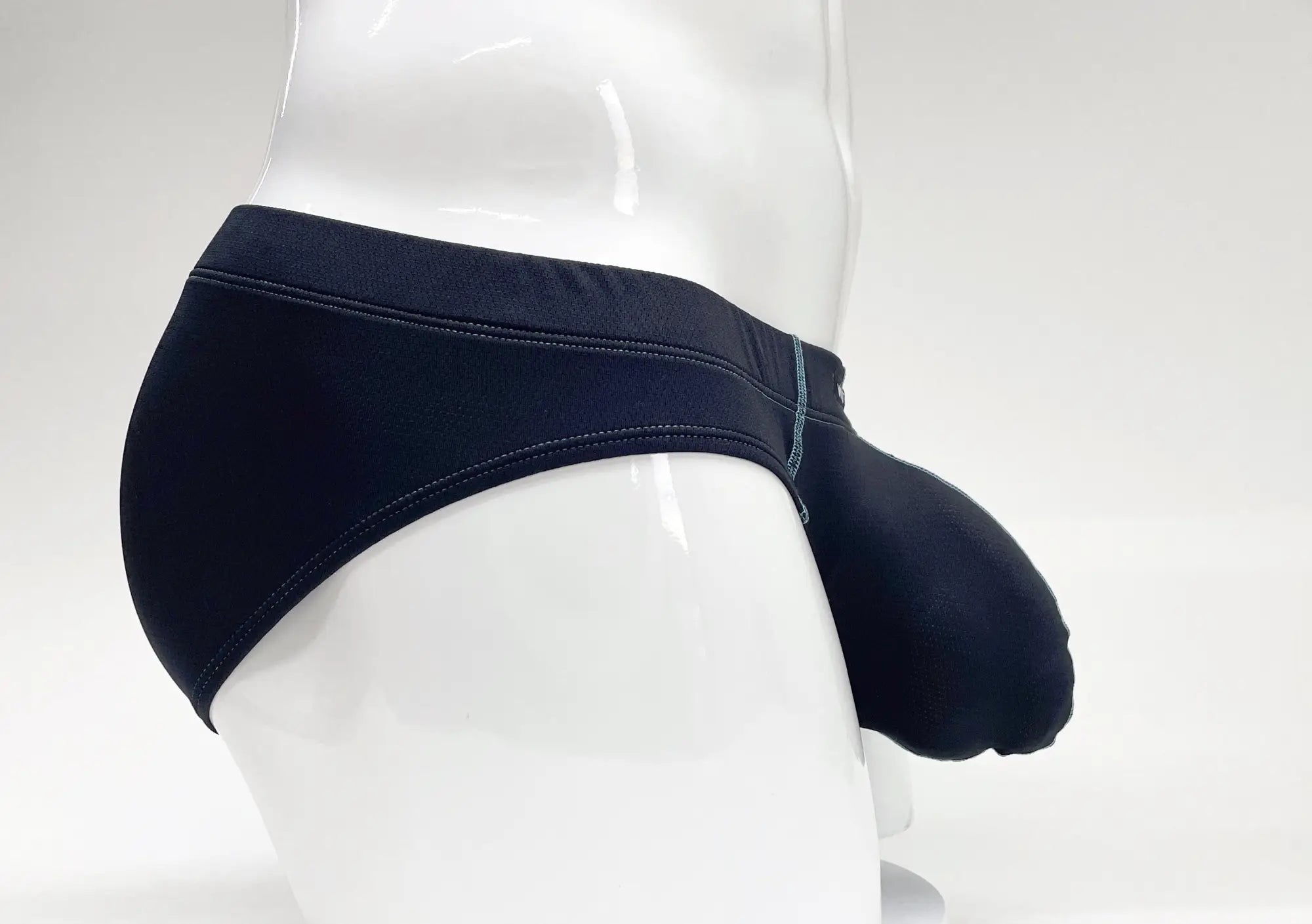 Side view of dark blue Stitch Big Boy pouch briefs on a white mannequin, featuring contrast stitching and a contoured fit.