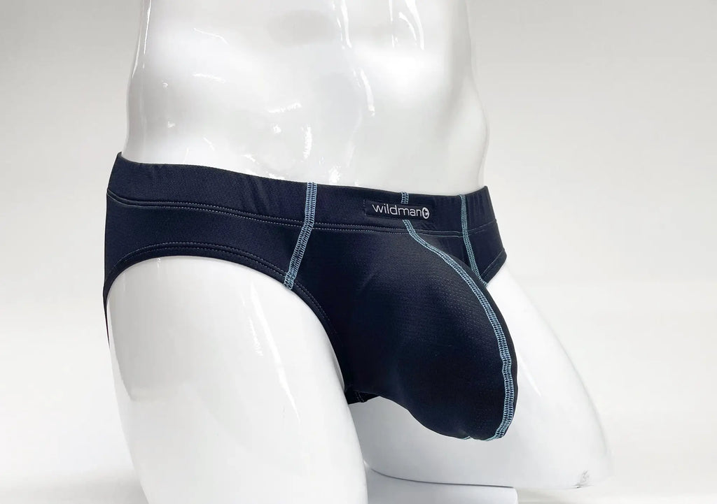 Dark blue pouch brief on a mannequin, featuring light blue contrast stitching and a WildmanT logo on the waistband.