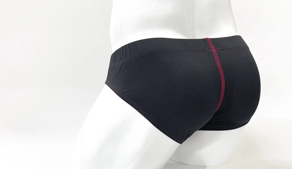 Back view of black perforated Stitch Big Boy pouch briefs with red stitching details on a white mannequin.