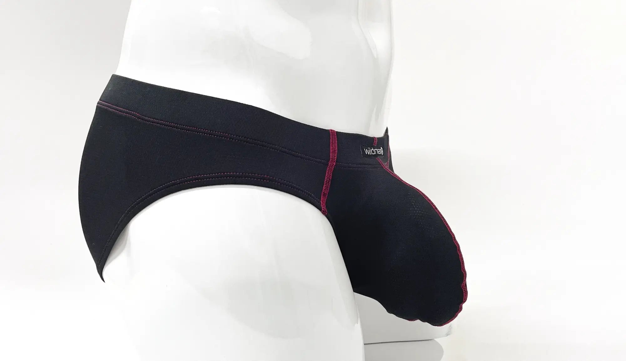 Stitch Big Boy Pouch Brief in black with red contrast stitching, shown from the side on a white mannequin.