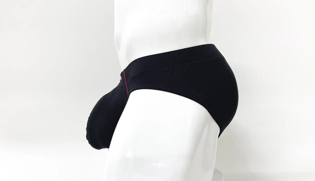 Side view of a black pouch brief with red stitching on a mannequin torso against a white background.