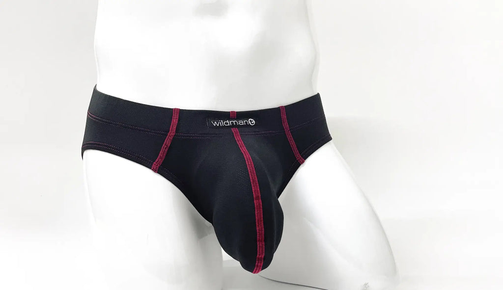 Black pouch brief with red contrast stitching and Wildman logo waistband, shown on a white mannequin.