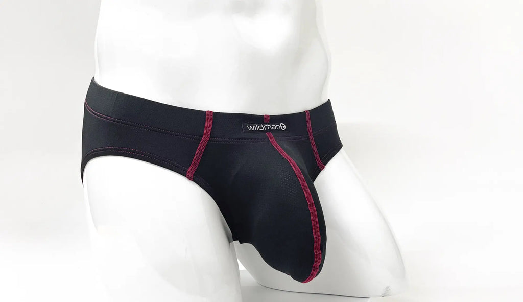 Black pouch brief with red contrast stitching and Wildman logo on the waistband, shown on a white mannequin.