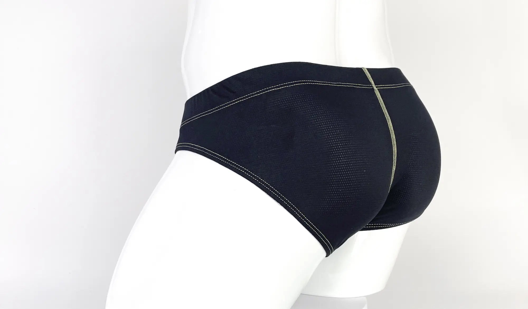 Black Stitch Big Boy pouch briefs on a white mannequin featuring a textured mesh fabric and yellow contrast stitching.