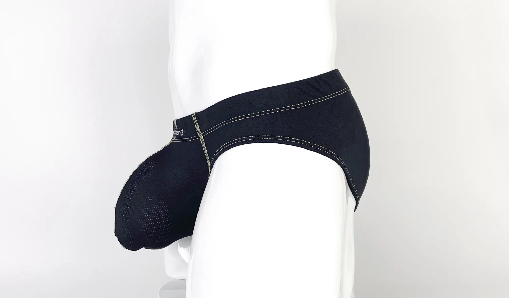 Black Stitch Big Boy pouch brief on a mannequin, featuring textured fabric and contrasting yellow stitching detail.