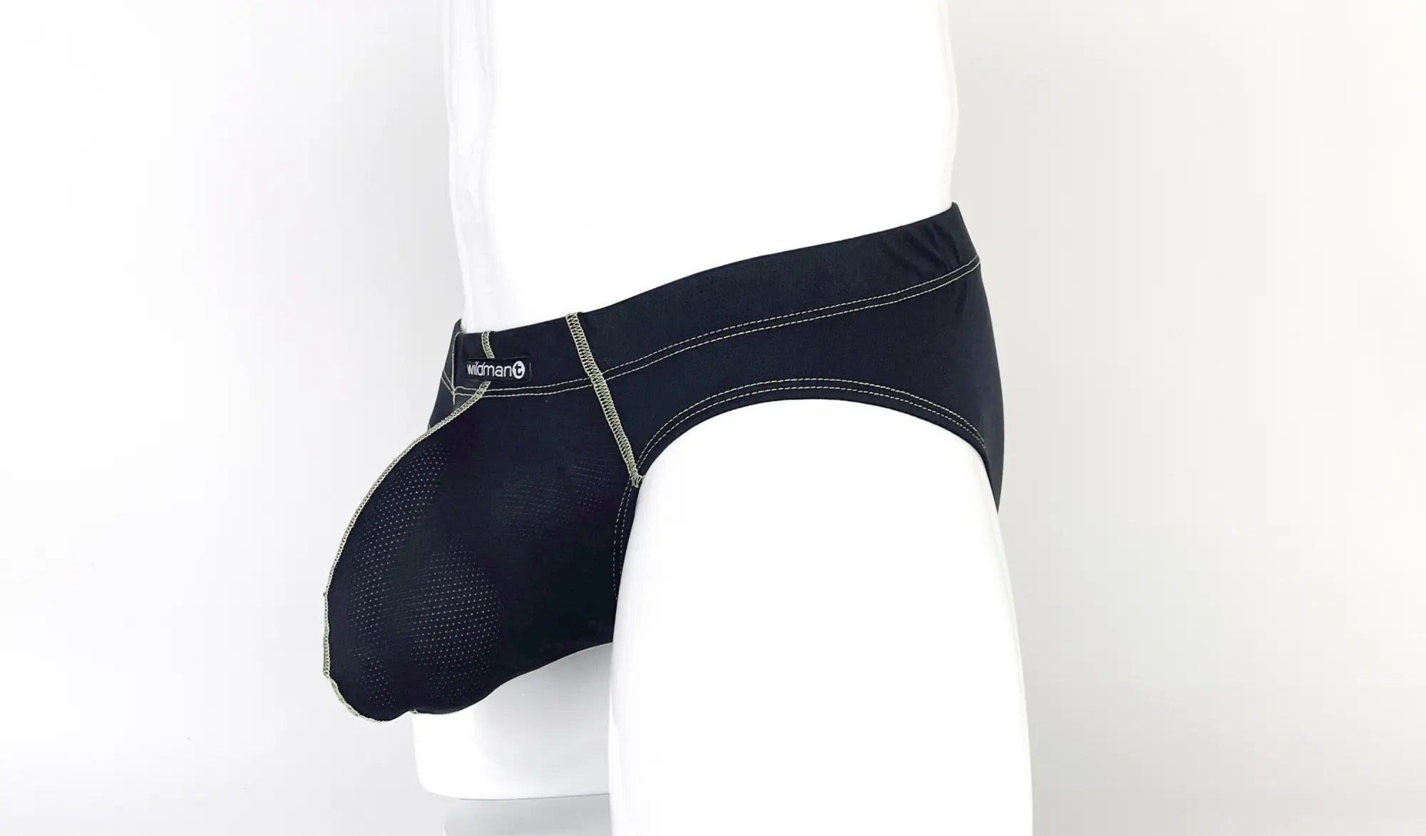 Black pouch brief with yellow contrast stitching and a small Wildman brand logo, shown from a side angle on a mannequin.