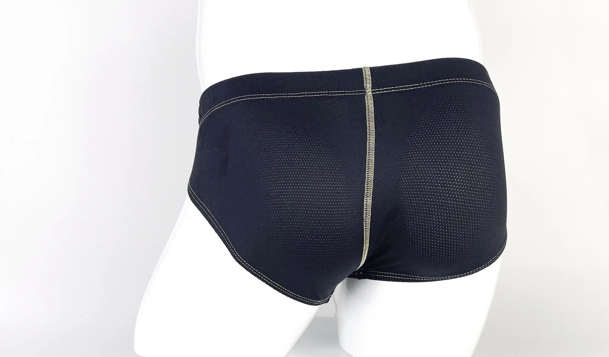 Stitch Big Boy Pouch Brief in navy blue with perforated fabric, yellow contrast stitching, and a center back seam.