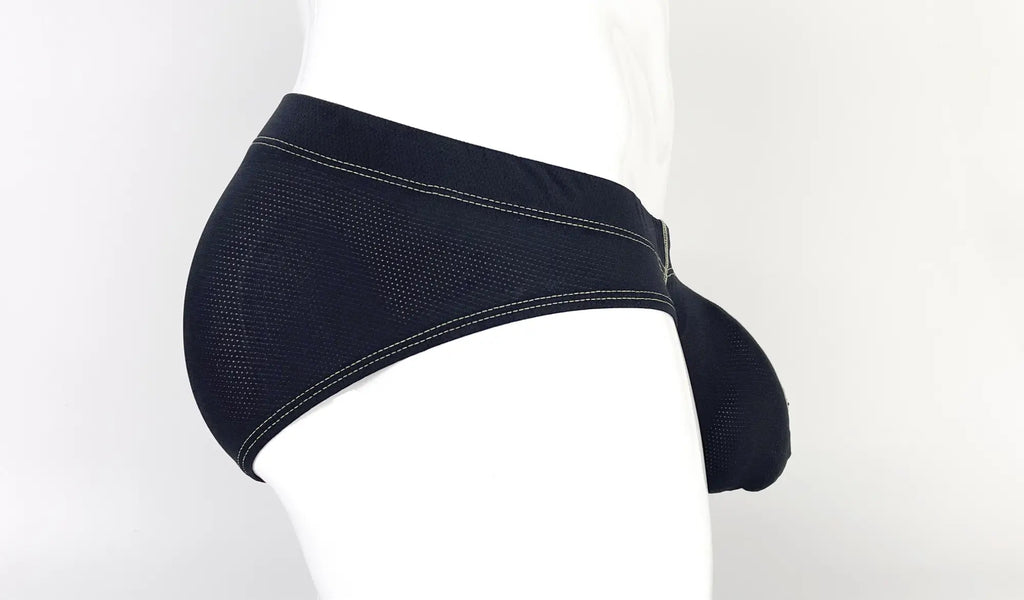 Black mesh pouch brief with yellow contrast stitching, worn on a white mannequin torso from a side profile view.