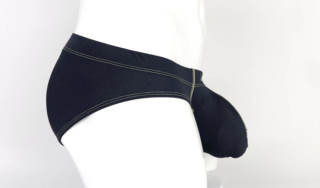 Side view of a black, mesh-textured pouch brief with yellow contrast stitching on a white mannequin.