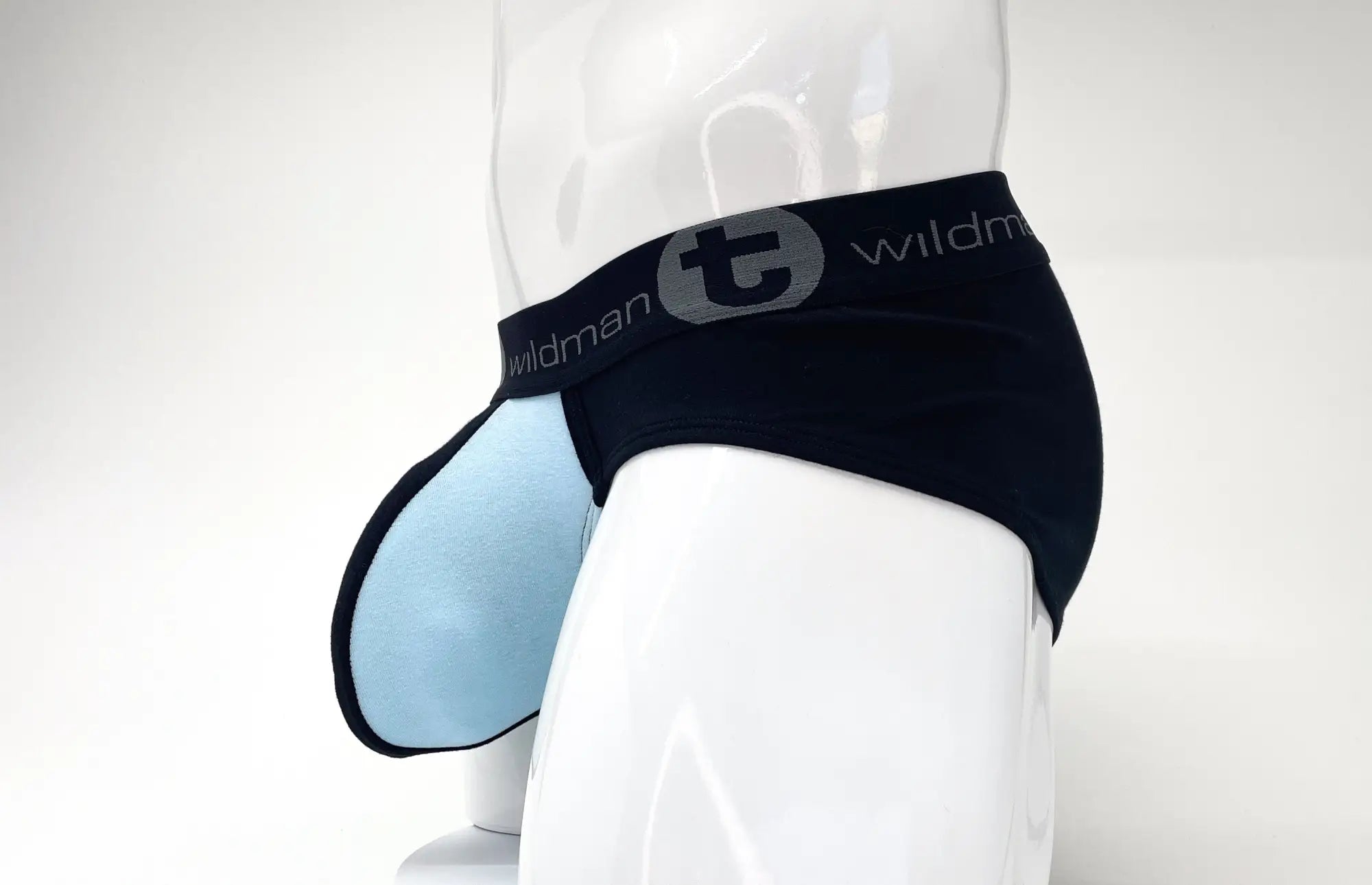 Black and light blue pouch brief on a mannequin, featuring a Wildman logo waistband.