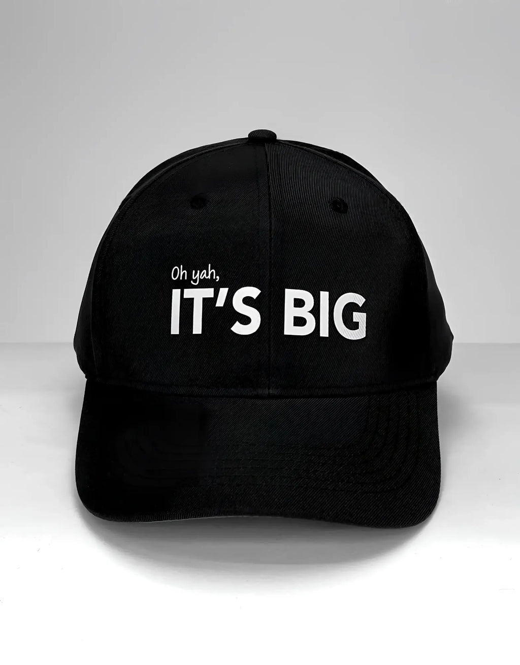 Black baseball cap featuring the text "Oh yah, IT’S BIG" embroidered in white on the front.
