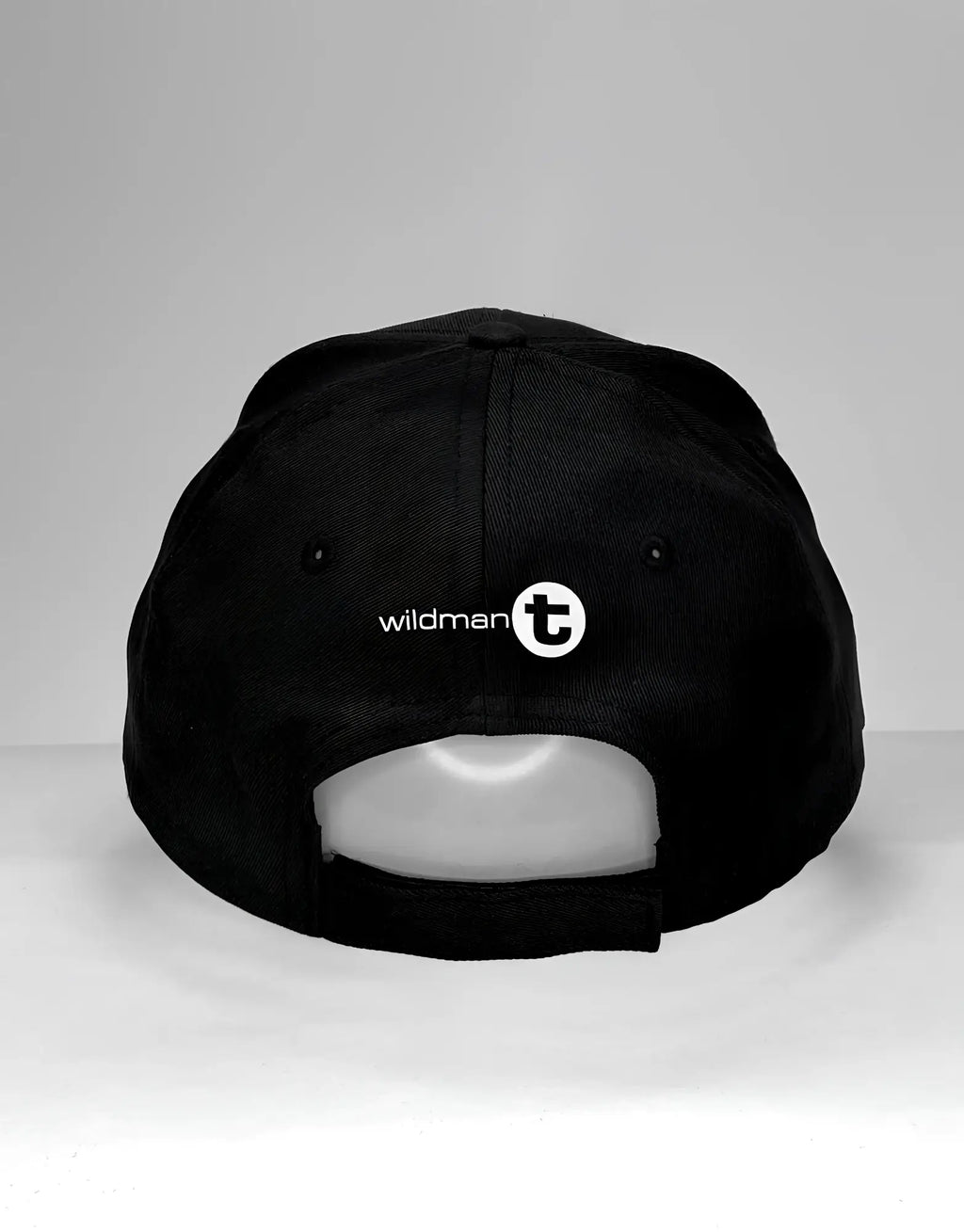 Back view of a black baseball cap featuring a white "wildman t" logo above the adjustable velcro strap.