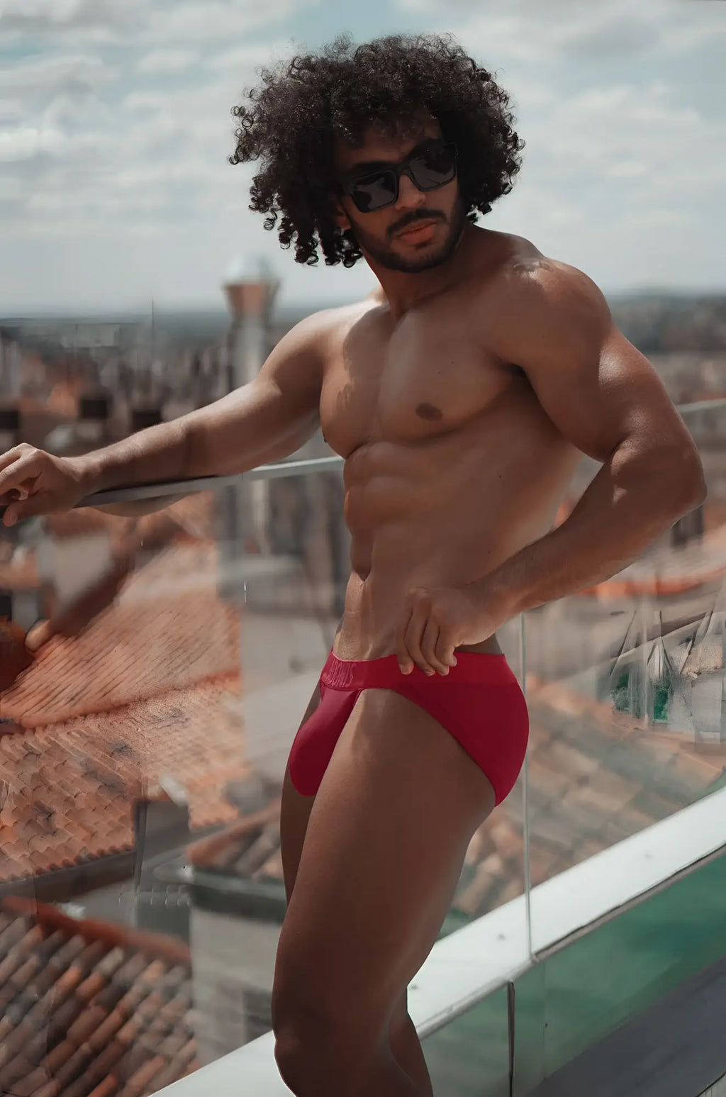 Wine jock-brief red swim trunks with snug fit and visible waistband designed for comfortable swimwear use