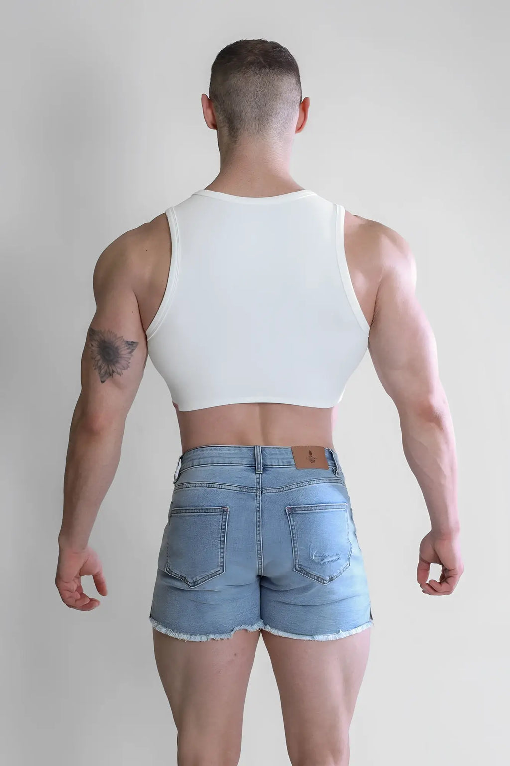 White wrapped up ribbed crop tank featuring a fitted design with a rounded neckline in soft ribbed fabric
