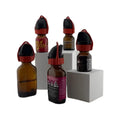 Several amber glass bottles with black and red caps labeled wyffr topper essential oil products displayed together