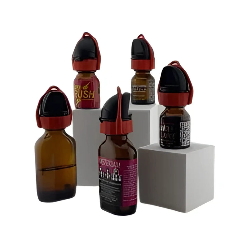 Several amber glass bottles with black and red caps labeled wyffr topper essential oil products displayed together