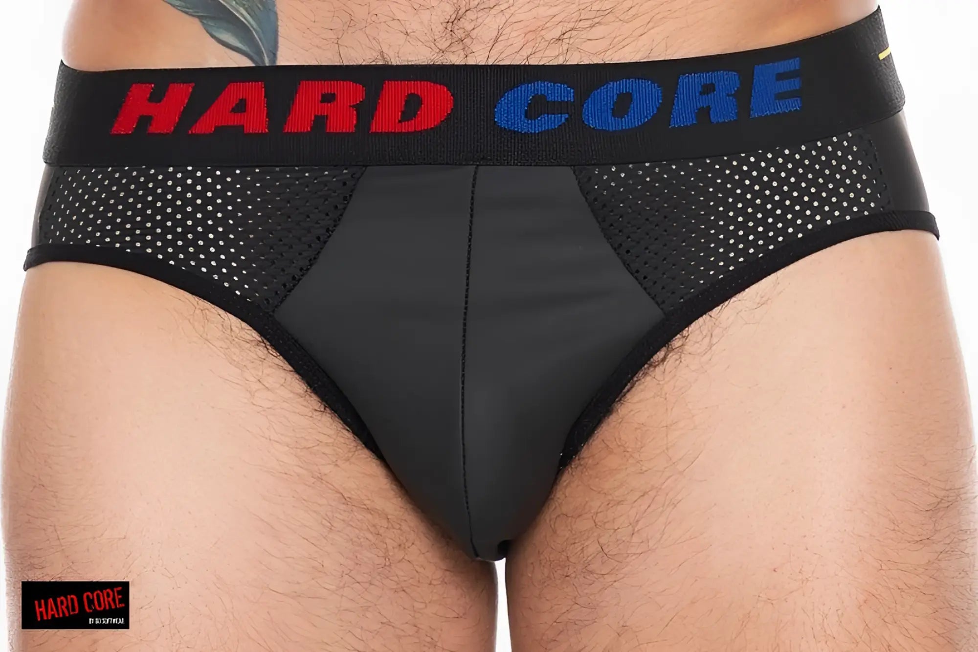 X backless brief in black mesh and solid fabric with hard core branding in red and blue on the waistband