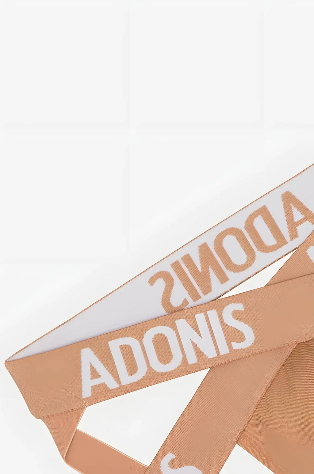 Tan woven ribbon with bold white adonis lettering on x nude jock waistband for stylish support and comfort
