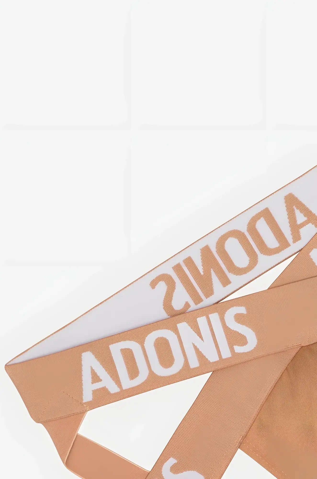 Tan woven ribbon with bold white adonis lettering on x nude jock waistband for stylish support and comfort