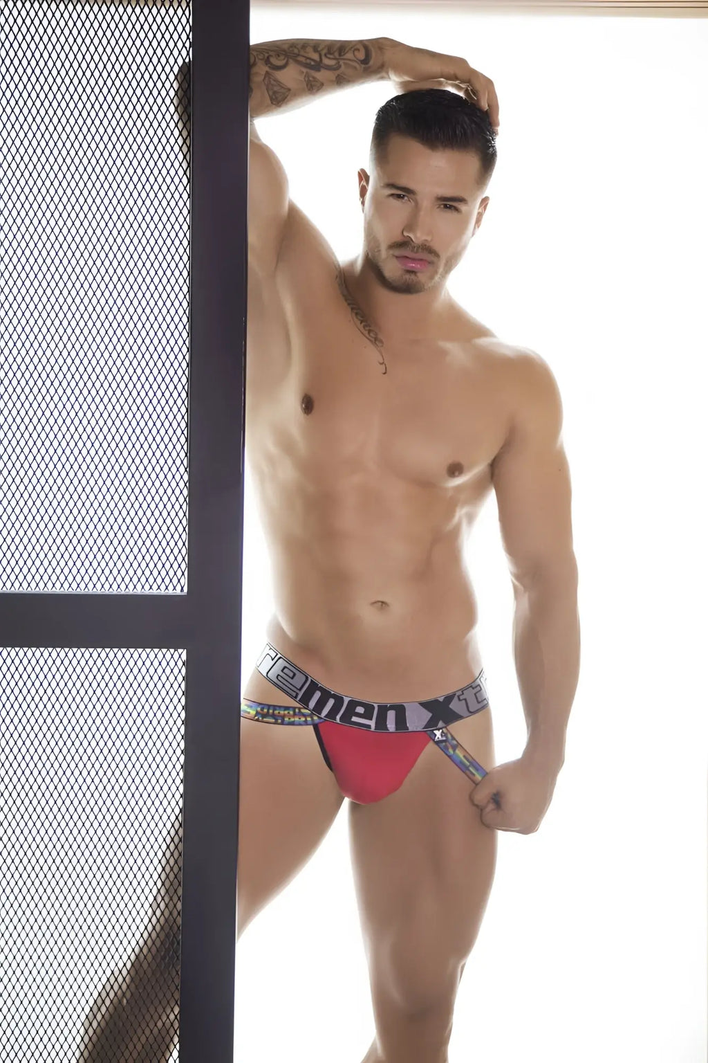 Red and black microfiber pride jockstrap with bold homemen x logo on the waistband xtremen 91084 model