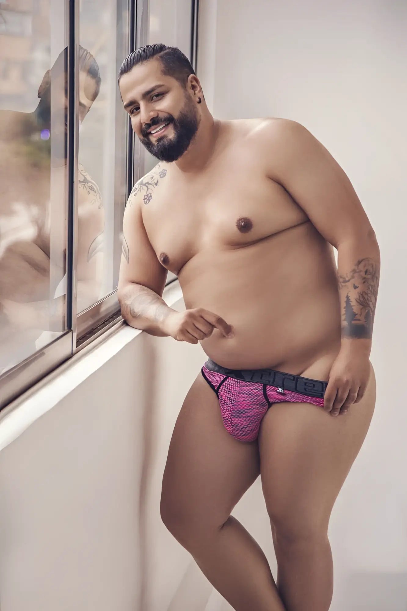 Xtremen 91100x microfiber mesh thong in pink with black trim and visible brand logo on waistband