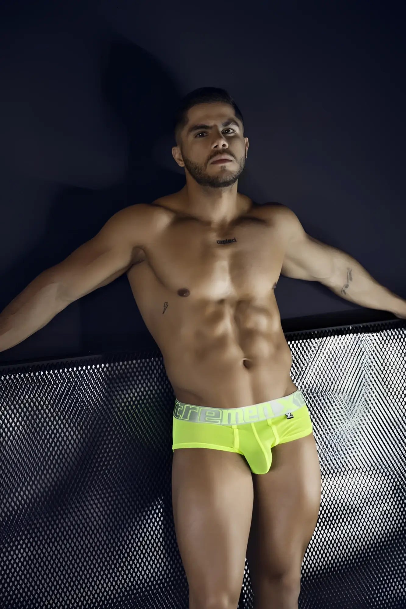 Bright neon yellow microfiber briefs with a white ere elastic waistband featuring black lettering