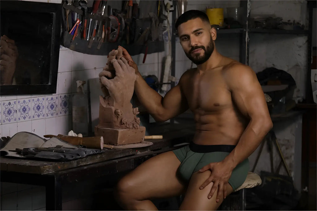 A clay sculpture hand in mid gesture shaped by artist hands with xtremen 91252 microfiber mesh trunks military green