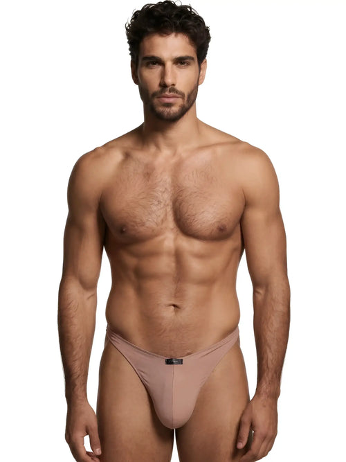 A model wearing a light brown Xtremen thong with a central brand logo tab, isolated against a white background.