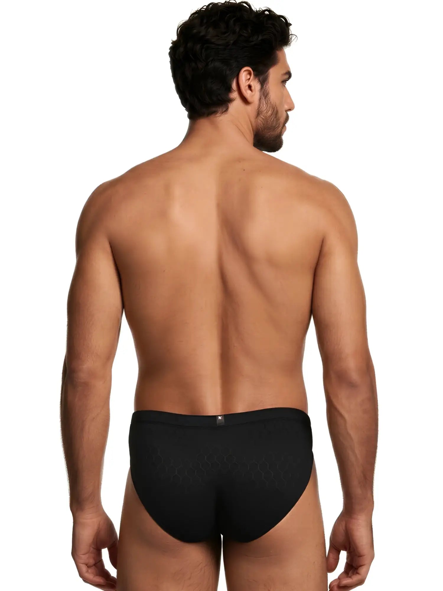 Back view of a man wearing black Xtremen briefs with a subtle honeycomb pattern.