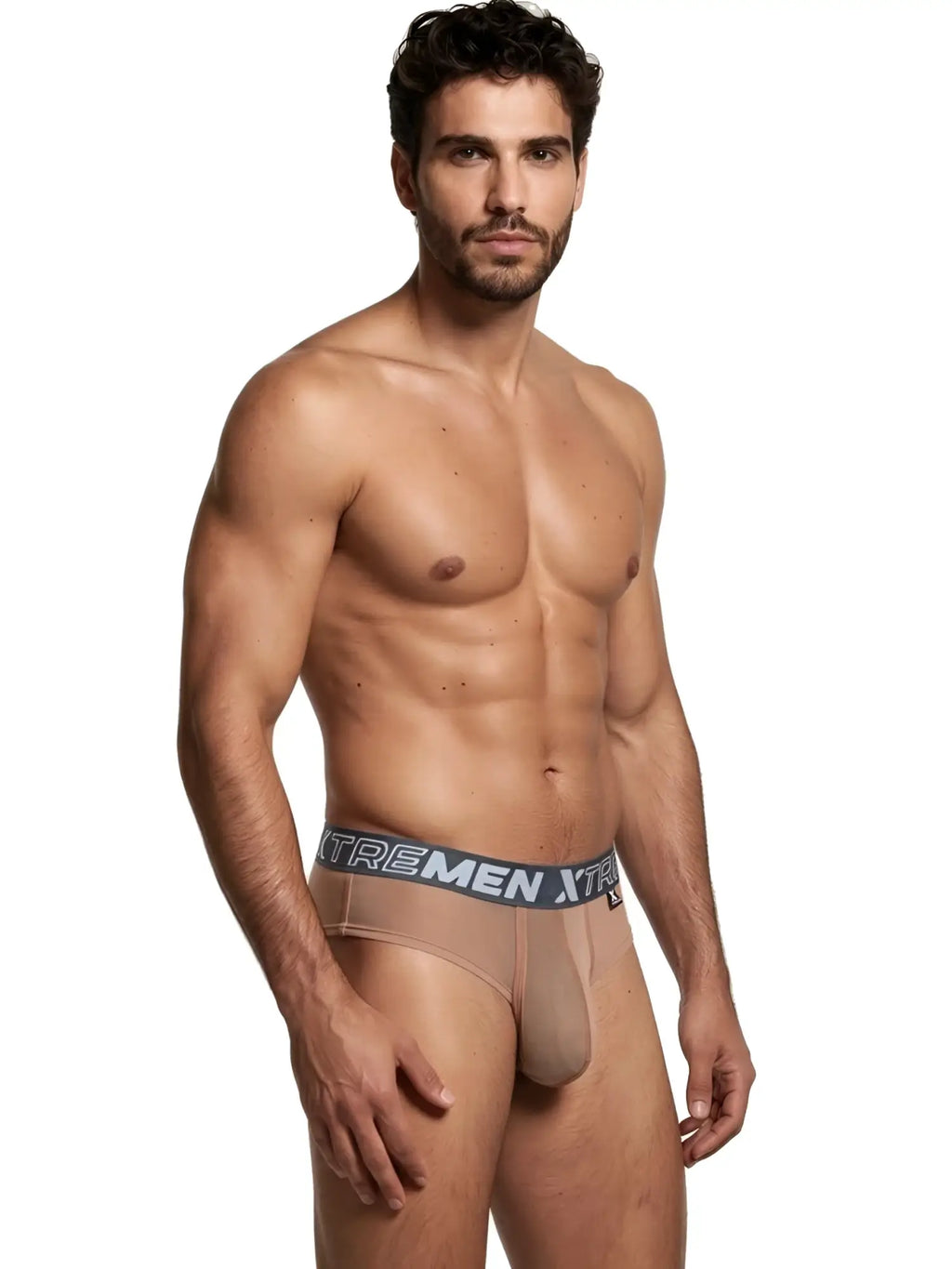 Model wearing nude-colored Xtremen sheer briefs with a grey branded elastic waistband.