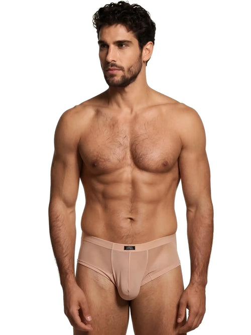 Model wearing nude, semi-sheer Xtremen briefs with a center-seam pouch and branded waistband.