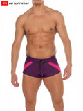 Purple and pink Zanzibar square-cut swim trunks with drawstring waistband designed for athletic use