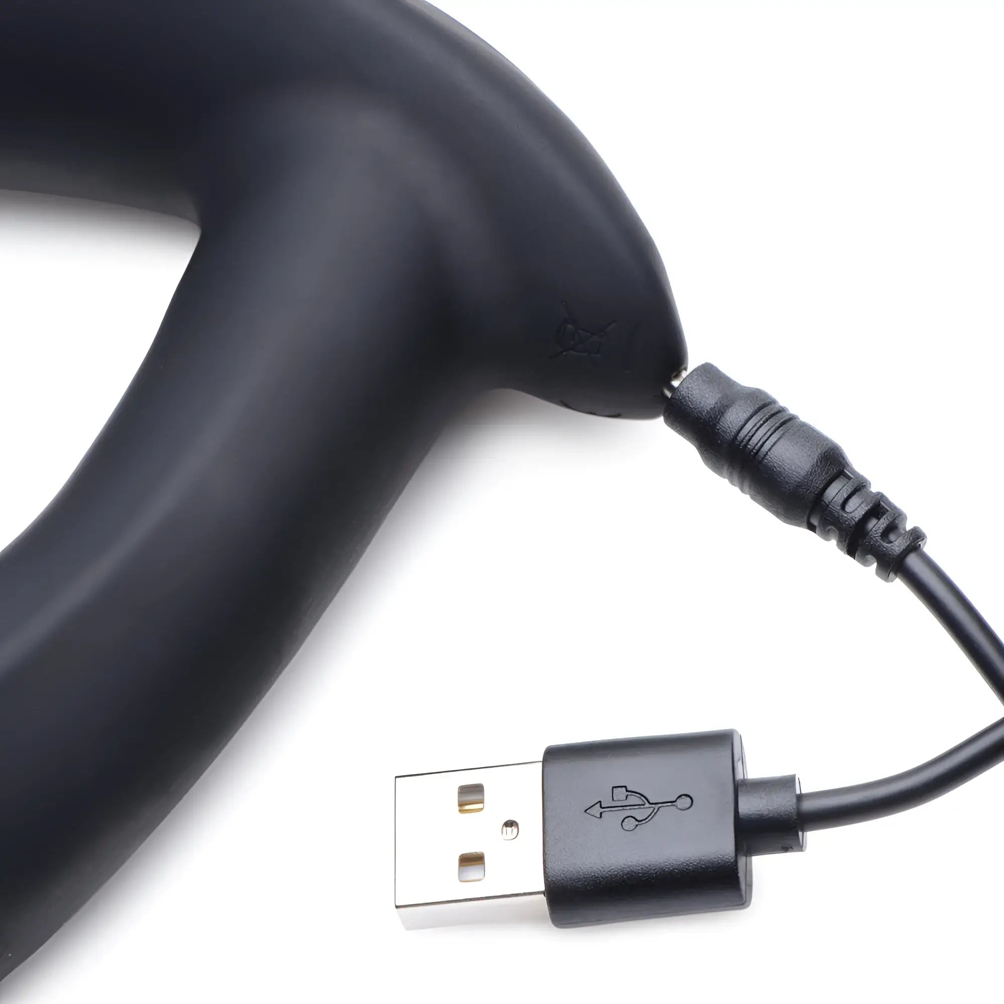 Black matte silicone Zeus E-Stim prostate massager shown being charged with a black USB cable on a white background.