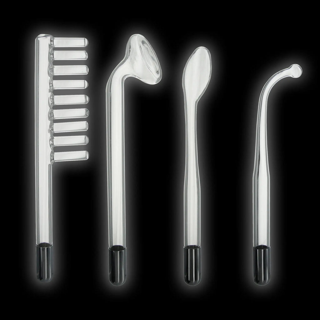 Zeus Twilight Wand set: four clear, glass electrostimulation attachments with black bases against a black background.