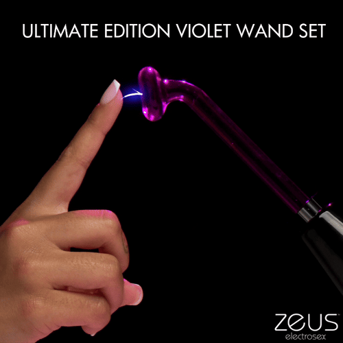 Zeus Electrosex Ultimate Edition Violet Wand: A glowing purple glass electrode sparks toward a fingertip on black.