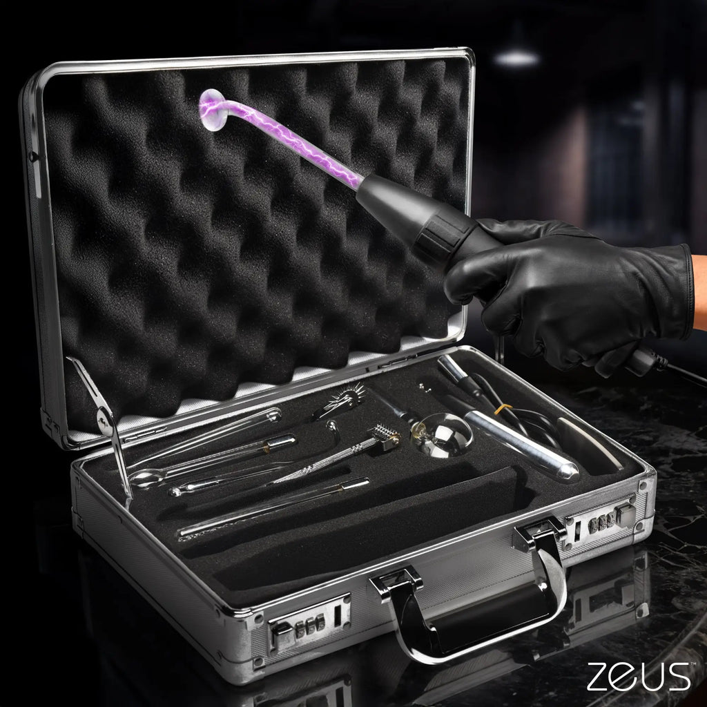 Zeus Electrosex Ultimate Edition Violet Wand set in a silver case with various glass attachments and active electrical glow.